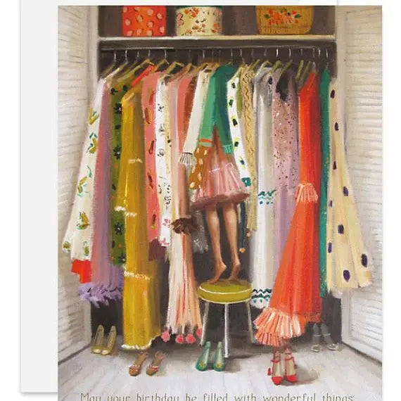 An artisan made, birthday greeting card of a closet filled with hanging dresses, scarves, and shoes, with a woman standing on a stool in the center. The artwork is presented on a white background with a small line of text at the bottom.