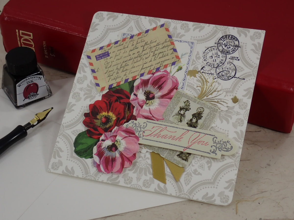 A handcrafted Thank You greeting card with vintage-style floral illustrations, postage stamps, a postmark, and a 'Thank You' ribbon banner.