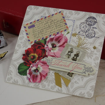 A handcrafted Thank You greeting card with vintage-style floral illustrations, postage stamps, a postmark, and a 'Thank You' ribbon banner.