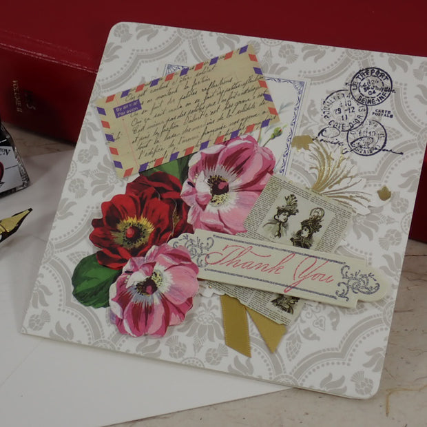 A handcrafted Thank You greeting card with vintage-style floral illustrations, postage stamps, a postmark, and a 'Thank You' ribbon banner.