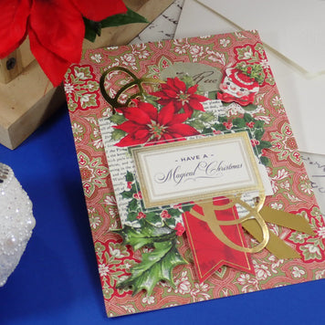A handcrafted Christmas greeting card. Red Poinsettias and a happy snowman face. Text says 