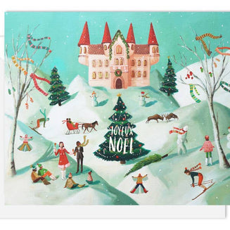 An Artisan made, Christmas greeting card featuring a whimsical winter village scene with a castle, snow-covered hills, people skiing and playing, decorated trees, and a central Christmas tree reading 'JOYeux NOEL'.