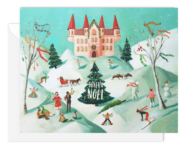 An Artisan made, Christmas greeting card featuring a whimsical winter village scene with a castle, snow-covered hills, people skiing and playing, decorated trees, and a central Christmas tree reading 'JOYeux NOEL'.
