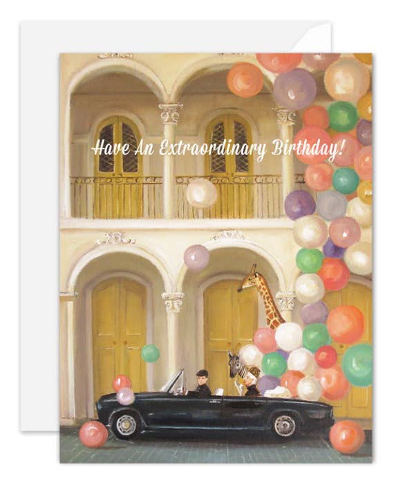 Artisan made, Birthday greeting card with a car and giraffe under colorful balloons and text 'Have An Extraordinary Birthday!'.