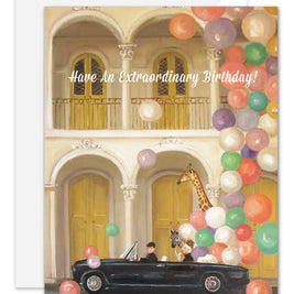 Artisan made, Birthday greeting card with a car and giraffe under colorful balloons and text 'Have An Extraordinary Birthday!'.