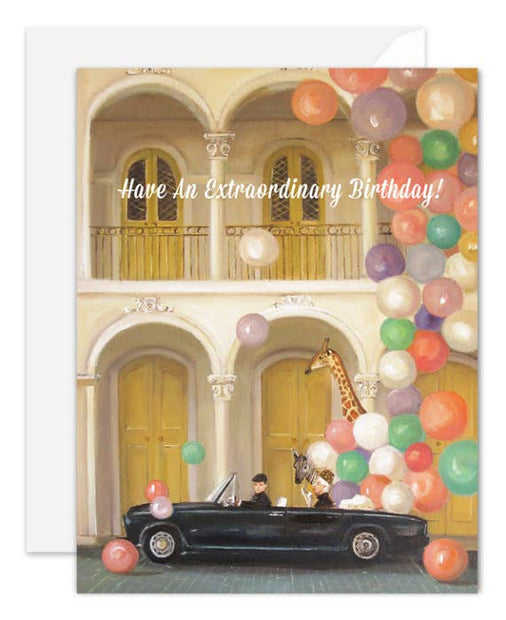 Artisan made, Birthday greeting card with a car and giraffe under colorful balloons and text 'Have An Extraordinary Birthday!'.